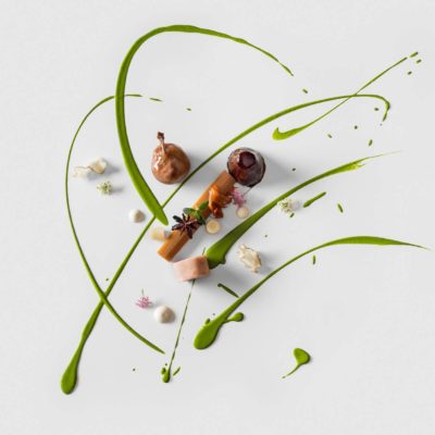 Quail Leg with Rhubarb and Artichoke A quail leg with a rhubarb baton over a parsley coulis and puree with roasted and shaved artichokes and garnished with star anise and mini white and purple flowers prepared by Chef Christoph Zangeri of The Hotel Tannenhof in Austria.